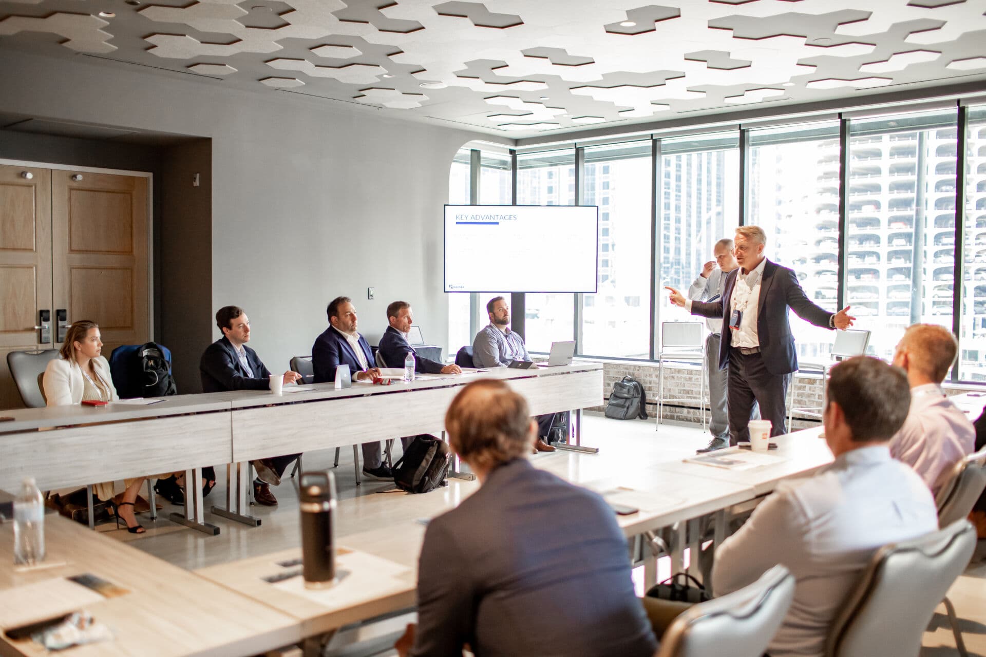 Executives seated around u-shaped conference room table for discussions at Shore Capital Partners Executive Leadership Academy